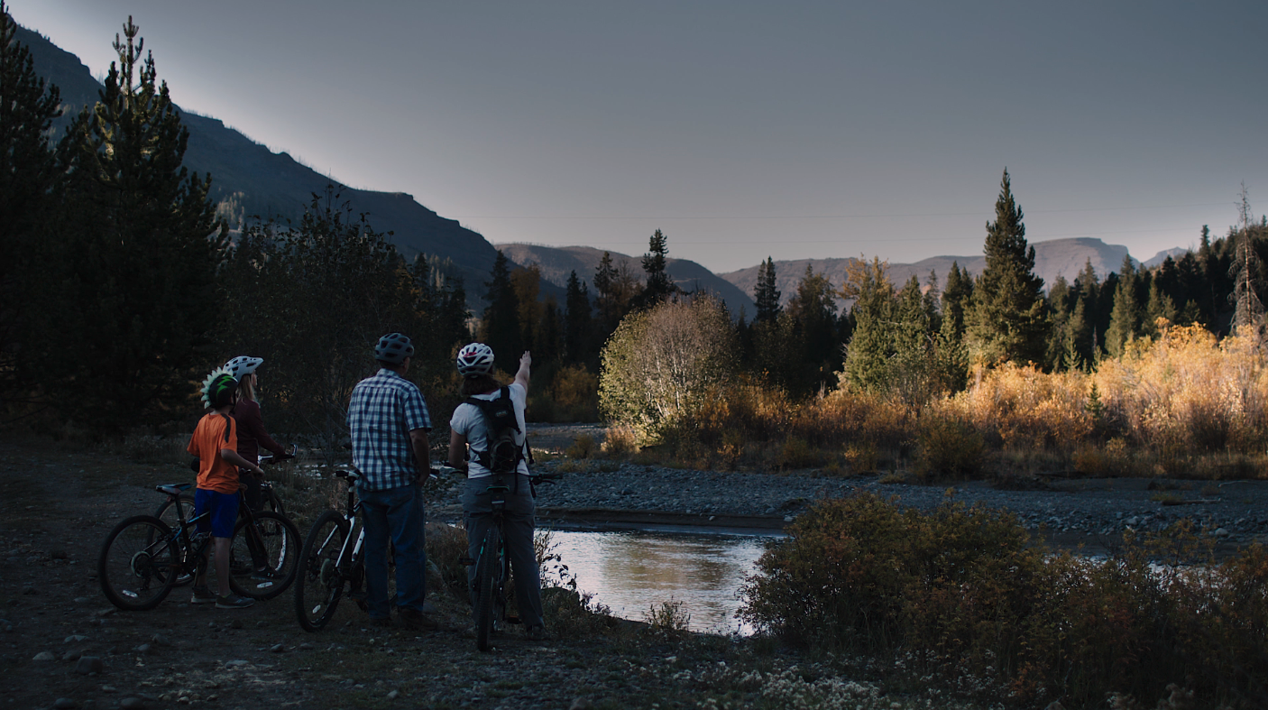 A family enjoys the view on a bike ride through Cody Yellowstone